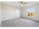Bedroom with neutral carpeting, a ceiling fan, and a window with an outside view at 8965 Snowberry Ct, Zionsville, IN 46077