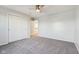 Bedroom featuring neutral carpeting, a ceiling fan, and a double door closet at 8965 Snowberry Ct, Zionsville, IN 46077