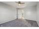 A bedroom with neutral paint, gray carpet, ceiling fan, and a closet at 8965 Snowberry Ct, Zionsville, IN 46077