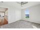 This bedroom has neutral paint, carpet, ceiling fan, and a large window for natural light at 8965 Snowberry Ct, Zionsville, IN 46077