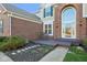 Charming entryway with a covered porch, a bench, and manicured landscaping, creating a welcoming entrance at 8965 Snowberry Ct, Zionsville, IN 46077