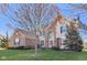 Attractive two-story brick home with an arched entryway, well-maintained lawn, and mature landscaping at 8965 Snowberry Ct, Zionsville, IN 46077