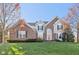 Beautiful two-story brick home with an arched entryway and manicured lawn, exuding curb appeal at 8965 Snowberry Ct, Zionsville, IN 46077