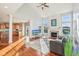 Bright living room featuring hardwood floors, a fireplace, large windows, and an open floor plan at 8965 Snowberry Ct, Zionsville, IN 46077