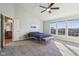 A main bedroom with a vaulted ceiling, large windows, bench, ceiling fan and a walk-in closet at 8965 Snowberry Ct, Zionsville, IN 46077