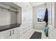 Mud room with custom cabinets, a dark countertop, and a window providing natural light at 8965 Snowberry Ct, Zionsville, IN 46077