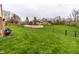 A lush green backyard with a mix of chain link and wood fencing surrounding the property at 8973 Sunningdale Blvd, Indianapolis, IN 46234