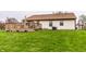 A well-maintained backyard featuring a deck, a grassy area, and mature trees at 8973 Sunningdale Blvd, Indianapolis, IN 46234