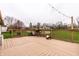 Spacious wooden deck with grilling area and string lights, perfect for backyard relaxation and entertaining at 8973 Sunningdale Blvd, Indianapolis, IN 46234