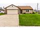 Lovely home boasts a two-car attached garage and well maintained lawn at 8973 Sunningdale Blvd, Indianapolis, IN 46234