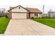 Delightful home features an attached two-car garage and concrete driveway at 8973 Sunningdale Blvd, Indianapolis, IN 46234