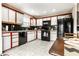 Well-equipped kitchen with black appliances and white cabinets offers a clean, modern aesthetic at 8973 Sunningdale Blvd, Indianapolis, IN 46234