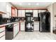 A modern kitchen with sleek black appliances and ample counter space, perfect for cooking at 8973 Sunningdale Blvd, Indianapolis, IN 46234