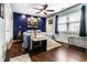 Comfortable bedroom with a ceiling fan, blue accent wall, and ample natural light at 8973 Sunningdale Blvd, Indianapolis, IN 46234