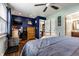 Stylish bedroom featuring a blue accent wall, wood floors, and open closet space at 8973 Sunningdale Blvd, Indianapolis, IN 46234