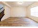 Spacious basement area with wood floors, a staircase, and a large window, providing ample natural light at 904 Adena Ln, Westfield, IN 46074