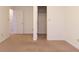 A beige, carpeted bedroom includes a closet and a doorway to another room at 904 Adena Ln, Westfield, IN 46074
