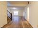 Bright entryway featuring wood floors, a staircase, and access to multiple rooms, creating an inviting atmosphere at 904 Adena Ln, Westfield, IN 46074