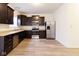 Modern kitchen featuring stainless steel appliances, dark cabinets, and wood floors, creating a functional and stylish space at 904 Adena Ln, Westfield, IN 46074