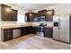 Modern kitchen featuring dark wood cabinetry, stainless steel appliances, and sleek countertops at 904 Adena Ln, Westfield, IN 46074