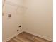A compact laundry area with utility connections and a wire shelf for storage at 904 Adena Ln, Westfield, IN 46074