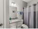 Bathroom features a single vanity, mirror, toilet and shower with curtain at 9925 Glendon Ct, McCordsville, IN 46055