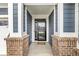 Inviting entryway with brick columns, a dark front door with glass, and a view to the outside at 9925 Glendon Ct, McCordsville, IN 46055