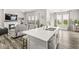 Open floor plan kitchen with white countertops, stainless steel appliances, and an island with a sink at 9925 Glendon Ct, McCordsville, IN 46055
