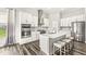 Kitchen featuring an island with seating, stainless appliances, and white cabinets at 9925 Glendon Ct, McCordsville, IN 46055