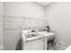 Bright laundry room features a wire shelf, outlets and modern, matching washer and dryer at 9925 Glendon Ct, McCordsville, IN 46055