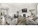 Living room with a fireplace, mantel, large tv, and comfortable seating at 9925 Glendon Ct, McCordsville, IN 46055