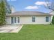 Backyard featuring a lawn, concrete patio, double doors, and vinyl siding, perfect for outdoor gatherings and relaxation at 10200 Cheswick Ln, Fishers, IN 46037