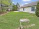 Large backyard featuring a stone bench, green lawn, and mature trees surrounding the property at 10200 Cheswick Ln, Fishers, IN 46037