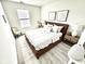 Bright bedroom boasts neutral decor, natural light, modern artwork, and comfortable furnishings, perfect for relaxation at 10200 Cheswick Ln, Fishers, IN 46037