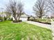 A cozy home featuring a well-manicured front yard with mature trees and an attached garage at 10200 Cheswick Ln, Fishers, IN 46037