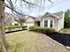Attractive brick home boasting a beautiful bay window, neat landscaping, and a two-car garage at 10200 Cheswick Ln, Fishers, IN 46037