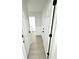 A hallway features white doors and light-colored flooring at 10200 Cheswick Ln, Fishers, IN 46037