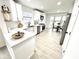 Modern kitchen featuring white cabinetry, stainless steel appliances, quartz countertops, and a cozy breakfast nook at 10200 Cheswick Ln, Fishers, IN 46037