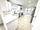 Bright kitchen features white cabinets, stainless steel appliances, and quartz countertops at 10200 Cheswick Ln, Fishers, IN 46037