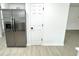 A kitchen features a stainless steel refrigerator and a white pantry door at 10200 Cheswick Ln, Fishers, IN 46037