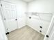 This laundry room includes a wire rack and white walls at 10200 Cheswick Ln, Fishers, IN 46037