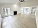 Airy living room with high ceilings, fireplace, light floors, and an open view to the kitchen at 10200 Cheswick Ln, Fishers, IN 46037