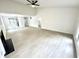 Spacious living area featuring vaulted ceilings, a modern light fixture, and light wood-look floors at 10200 Cheswick Ln, Fishers, IN 46037