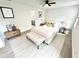 Serene main bedroom showcasing neutral tones, a ceiling fan, an ensuite bathroom, and a comfortable seating area at 10200 Cheswick Ln, Fishers, IN 46037