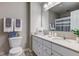 Bright bathroom with double vanity sinks, light walls, and a large mirror at 10602 Pintail Ln, Indianapolis, IN 46239