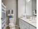 Bathroom featuring a white vanity with double sinks, toilet, and shower with curtain at 10602 Pintail Ln, Indianapolis, IN 46239