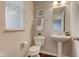 Clean bathroom featuring a pedestal sink, toilet, and neutral finishes at 10602 Pintail Ln, Indianapolis, IN 46239