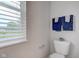 Bright bathroom showcases a toilet with decor and a window with natural light at 10602 Pintail Ln, Indianapolis, IN 46239