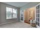 Comfortable bedroom with bright window, French doors to bath, and neutral walls at 10602 Pintail Ln, Indianapolis, IN 46239