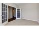 Comfortable bedroom with neutral carpet, glass doors, and neutral walls at 10602 Pintail Ln, Indianapolis, IN 46239